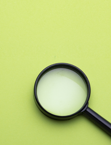 Magnifying glass on green background