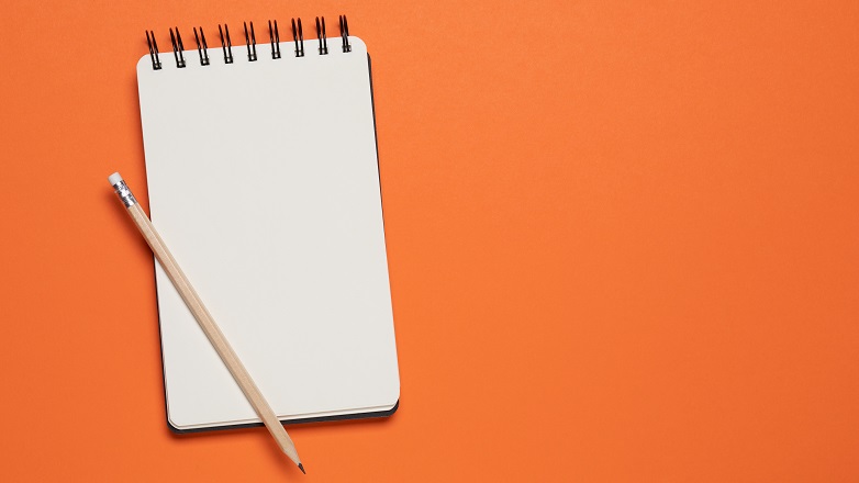 Orange notepad with pencil