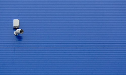 security camera on blue wall