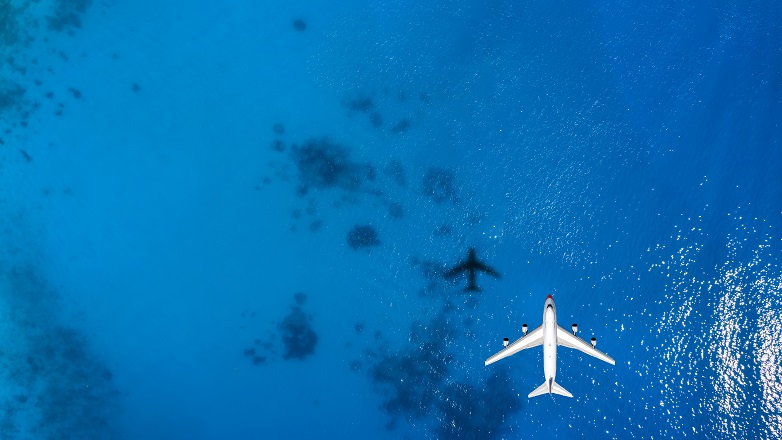 plane flying over body of water