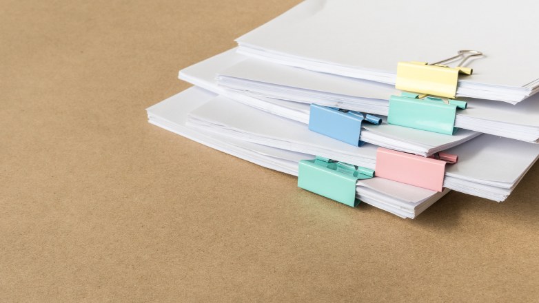 collection of files with coloured bulldog clips