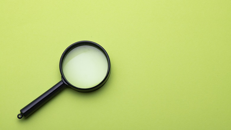 Magnifying Glass on green background