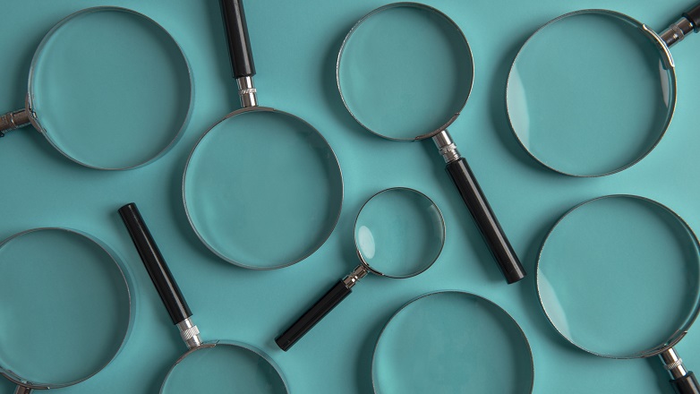Multiple Magnifying Glasses on teal background