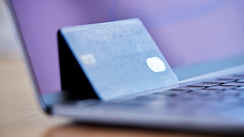Bank card propped up against laptop