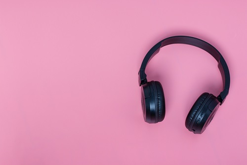 black headphones on pink background