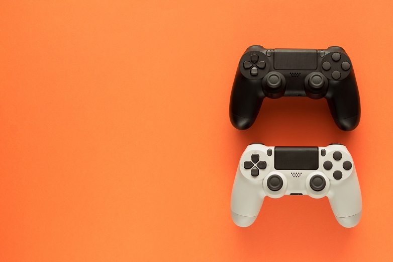 game controllers on orange background